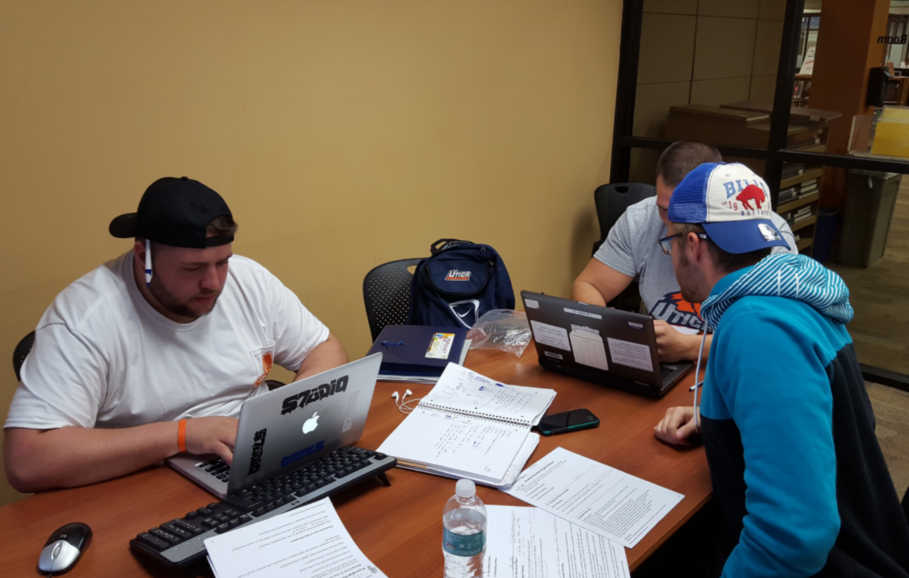 DJ Seitz, Sean Todd, Angelo Romeo gather in the library to work on a research project. Photo by Nicholas Souza