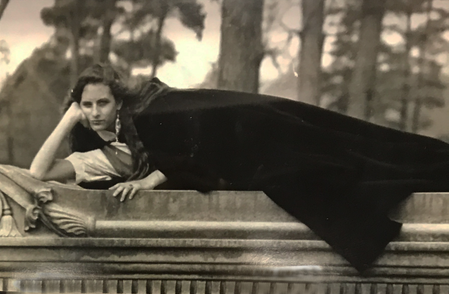 Marijean Levering, in her younger days, poses in a black cape. Source: A photo collage at The Marijean Levering Memorial Service. 