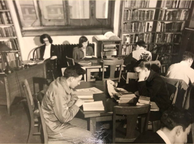 Students studying in the Utica Public Library, which housed UCs library from 1946-1948. Courtesy of UC Archives.