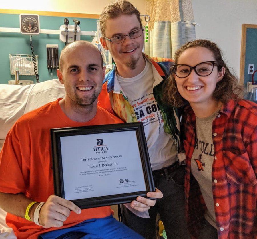 Peter Gaughan and Ann Ciancia delivering the Outstanding Senior Award to Lukus Becker at the hospital. Source: Lukus Becker