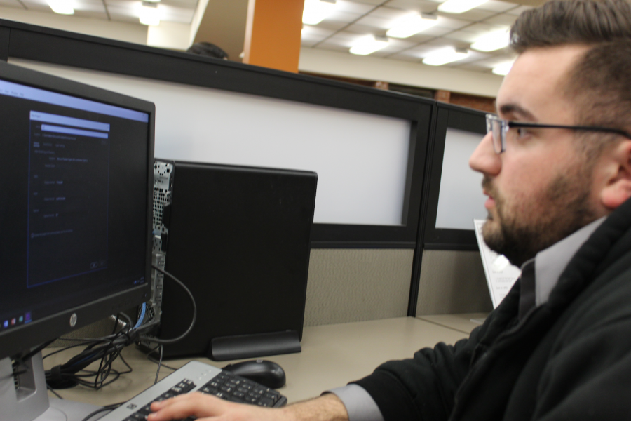 Josh Gubbins, junior in the sports journalism major, starts up the Adobe Premiere program he uses for a sports broadcasting class. Photo by Debra Born.