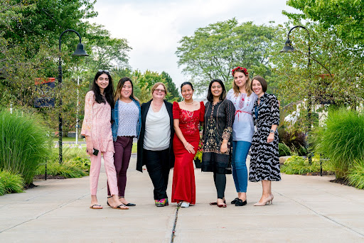 Four exchange students with the Utica College international office staff and visiting professor.
