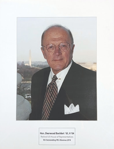 Photo of Sherwood Boehlert being honored as the Raymond Simon Institutes Outstanding Public Relations and Journalism Alumni in 2014. The photo hangs in 106 Hubbard Hall.