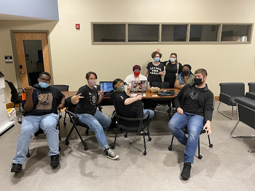 Members of The League of Extraordinary nerds gather around during their meeting in the new Wilcox Center.