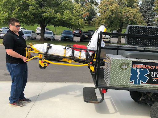 Captain of EMS Colby Kusinitz loads a stretcher into the Utica  College Emergency Management Services mule. 