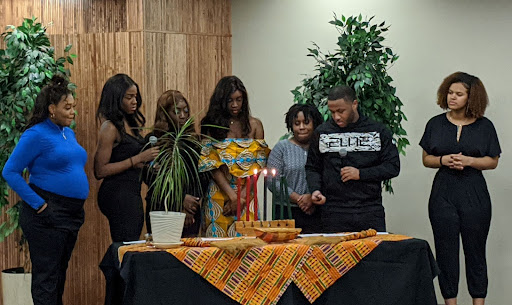 Members of the Utica College BSU during the 2019 Kwanzaa celebration, which included a ceremonial candle lighting.