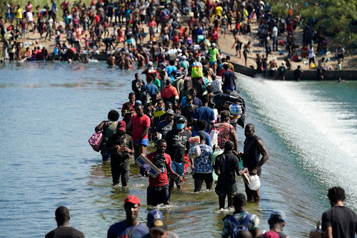 Haitian migrants use a dam in Texas to cross between the United States and Mexico.