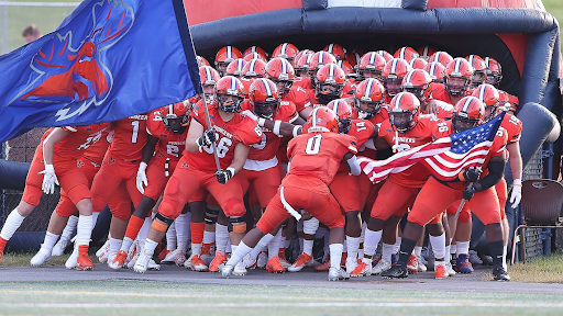 The Utica College football team gets hype before their conference matchup.