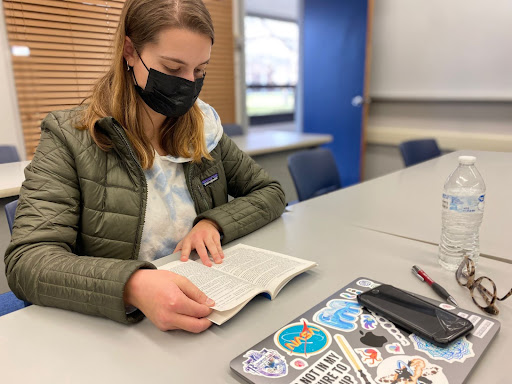 English major Anabella Rossi reads her book in preparation for a class discussion.