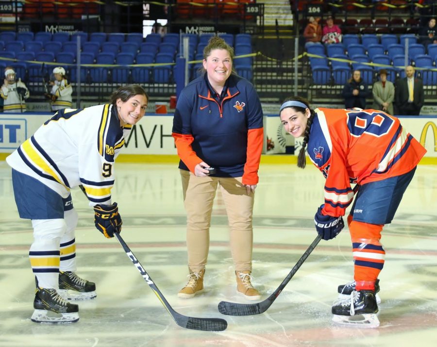 Utica+University+Sports+Information+Director+and+DIPG+cancer+survivor+Laurel+Simer+drops+the+puck+for+the+8th+annual+Gold+Ribbon+Game+at+Utica.+