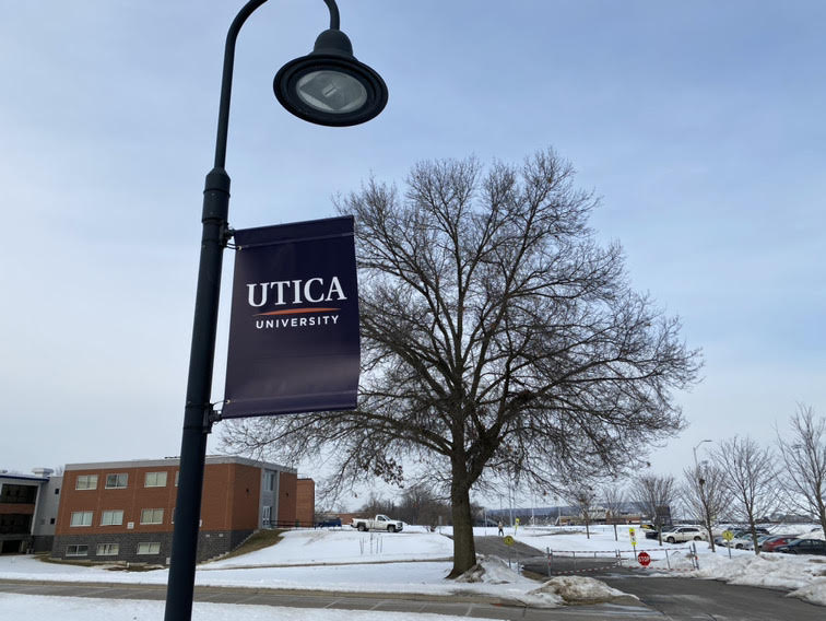 The new Utica University logo now hangs from multiple light poles across the campus.