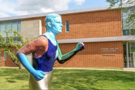 Runner with a Heart statue located outside of  White hall, created by Artist and Professor of Psychology Steven Specht