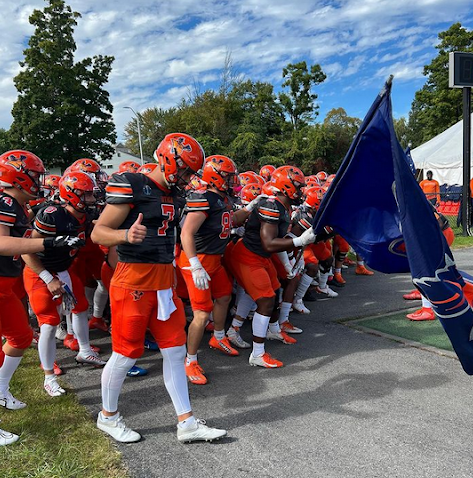 Photo of the Utica University Pioneers gearing up for the homecoming game from the Utica University Instagram page, @utica.university.