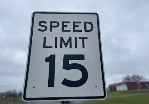 Sign showing the posted speed limit for the Utica University campus.