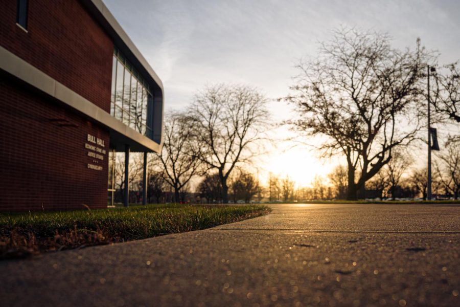 A+sunset+reflecting+the+sidewalk+at+Bull+Hall+on+the+university+campus.+