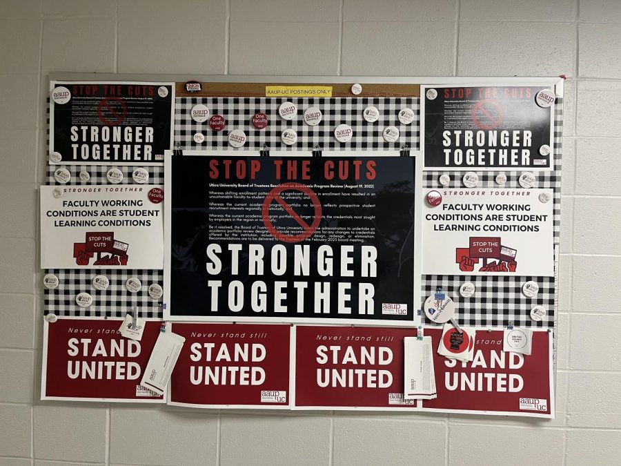 A bulletin board depicting a poster that claims in bold letters, “Stop The Cuts!” and “Stronger Together!”