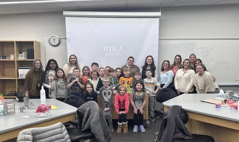 Utica University future educators depicted alongside visiting students.