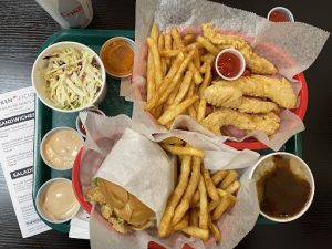 The crispy chicken sandwich and fries laid out on the table.