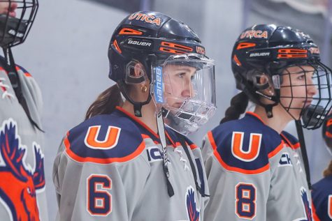 Three players from the Utica womens ice hockey team stand alongside each other. 