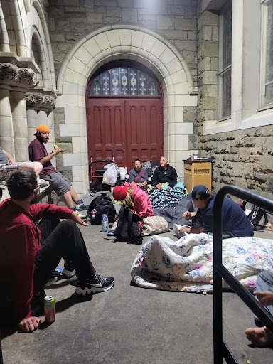 People in need set up outside the Morrow Warming Center, located in Cornerstone Community Church in Utica. Photo by Cathy Marsh. 
