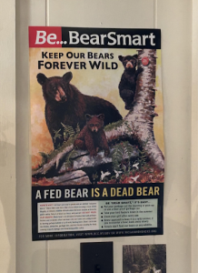 A poster educating visitors on bear safety hangs outside a store in Old Forge. Photo by Breannan O'Hara.