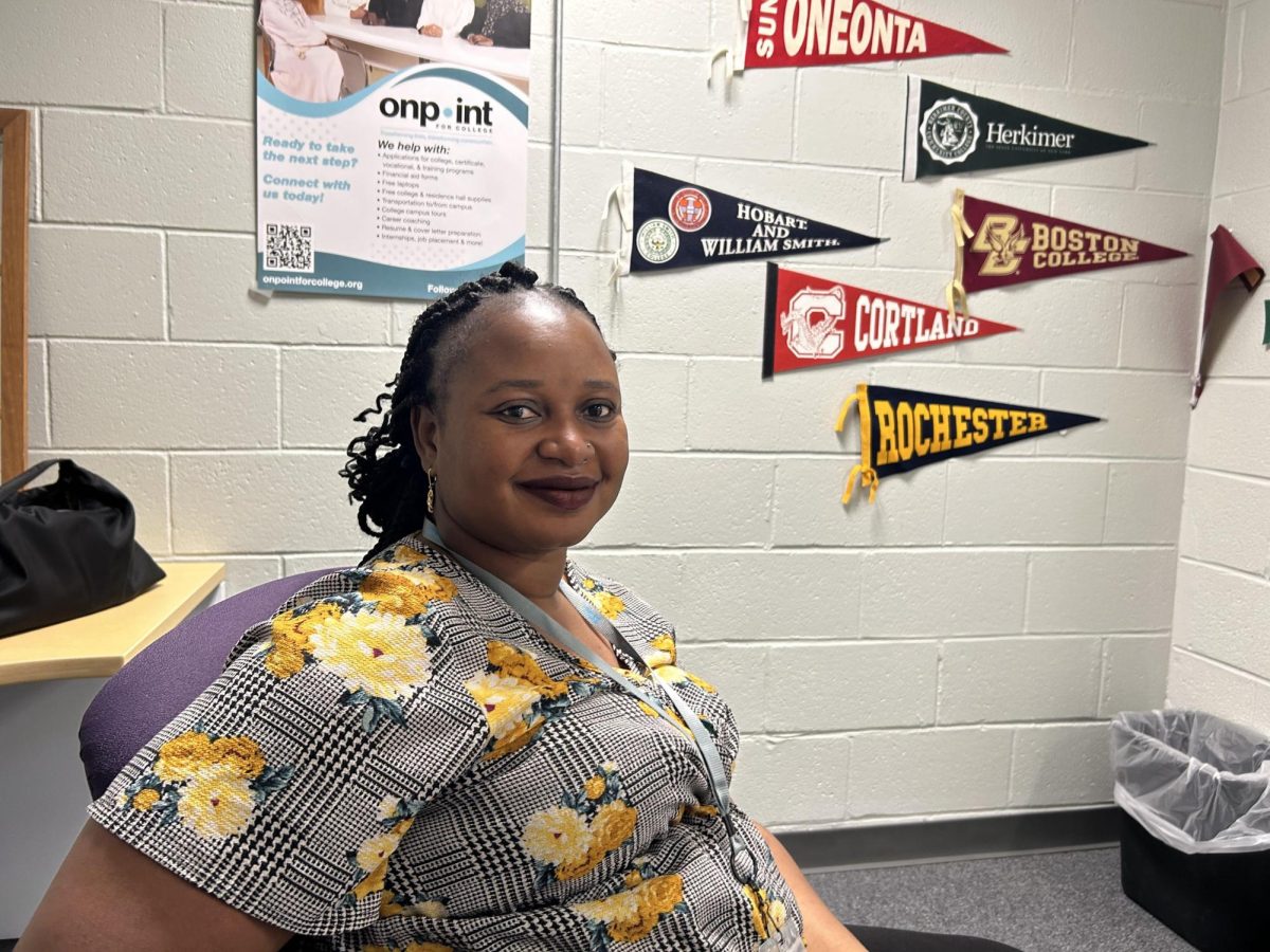 Hawa Peters, founder of Utica Royalties, sits in her Utica office. Photo by Brady Barnard. 