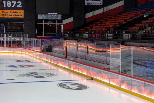 New LED dasherboards displaying fire around the ice rink at Adirondack Bank Center. Photo courtesy of Utica Comets. 

