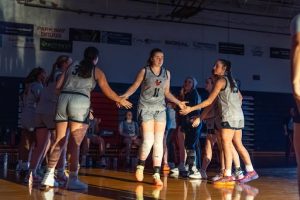 Vanessa Hall high fiving teammates as she starts at home game.