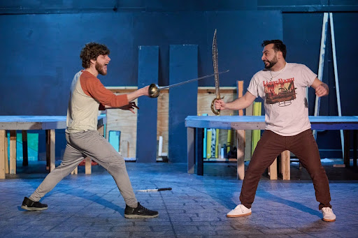 Cast members rehearse a scene from “Armada” in Strebel Auditorium. Photo by Jonas America.